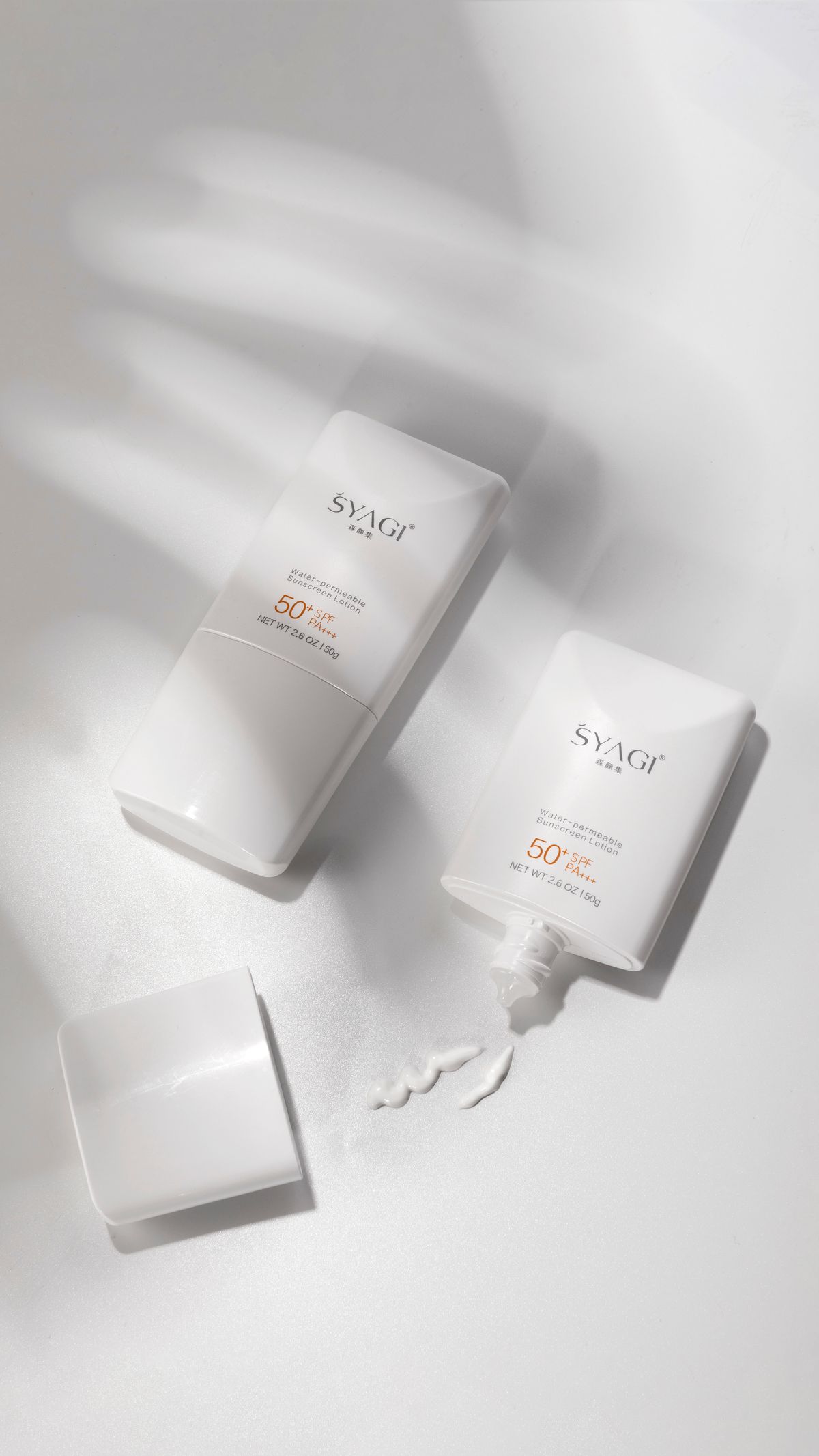 Two SPF 50 sunscreen bottles on a white surface with shadows, minimalist design.